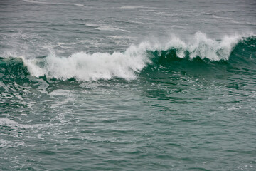 Obraz premium Surf Breaking. Waves break and crash on a rough sea.