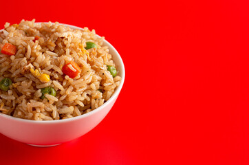 Bowl of Fried Rice on a Red Background