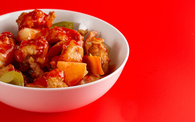 Bowl of Fried Chicken and Vegetables with Sweet and Sour Sauce