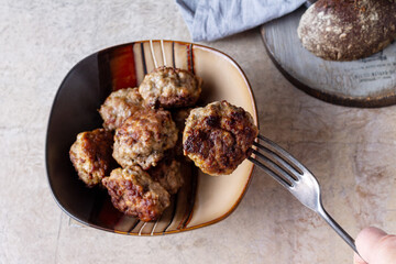 vintage fork with meatball on light background