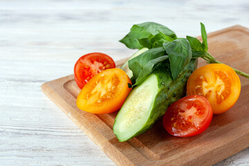 cucumber, yellow and red tomato and basil, healthy food concept, vegetable diet