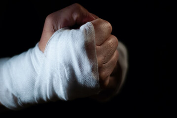 Hands of a boxer with white bandages prepared to fight in a sport battle