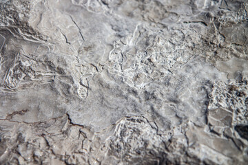 Fototapeta premium Stone texture covered with calcium deposits. Pamukale texture. Grey back.