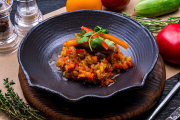 eggplant caviar on black plate on wooden table