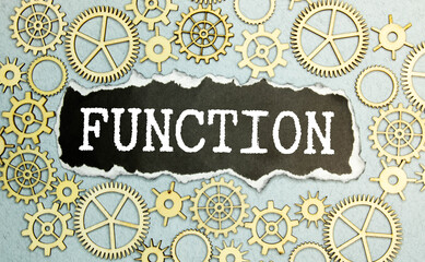 text on gray word function in small wooden letters with black font on a blue background