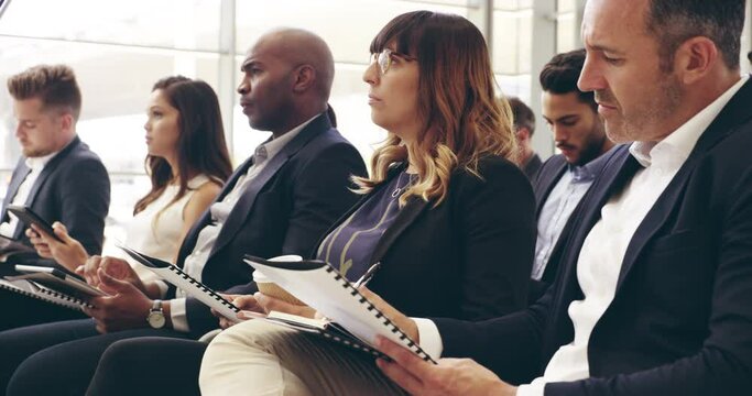 I agree with what youre saying. 4k video footage of businesspeople sitting in a convention center during a conference.