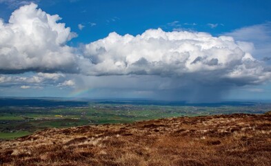 Fototapeta na wymiar Taken From Slieve Croob, Raincloud And Rainbow Over The Dromara Hills, Northern Ireland
