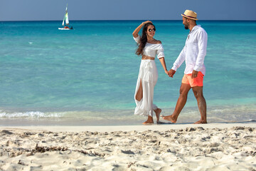 Romantic couple walking on the beach.