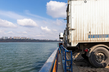 Close-up detail view of big industrial hopper truck body loaded on cargo ferry boat sailing on...