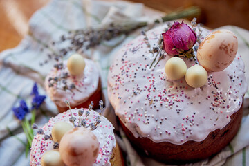 Easter cakes beautifully festive decoration with painted eggs lavender sequins flowers dried roses close-up