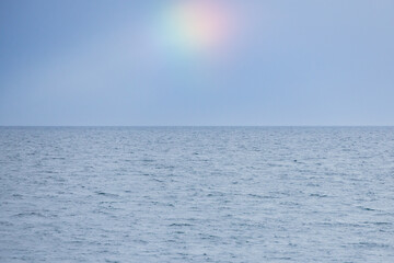 Obraz premium Blue sky, ocean and rainbow spot