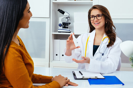 Doctor Giving Nasal Spray To Female Patient Healthcare Industry