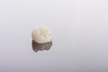 Qualified anatomic ceramic and zirconia crowns of human teeth close up macro isolated on black...