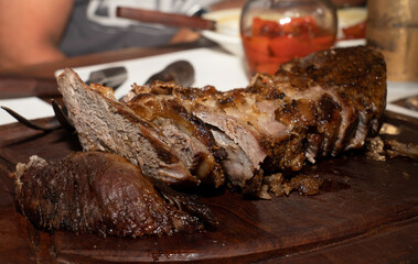 SLICED MEAT ON A WOODEN BOARD