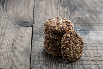 Healthy fitness cookies from sunflower seeds and sesame seeds with flax seeds on wooden table
