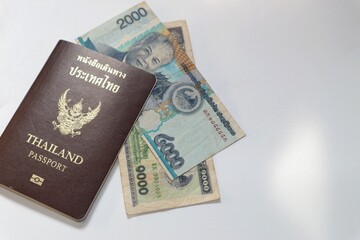 Lao money and Thai baht with passport on white background, currency, inflation concept
