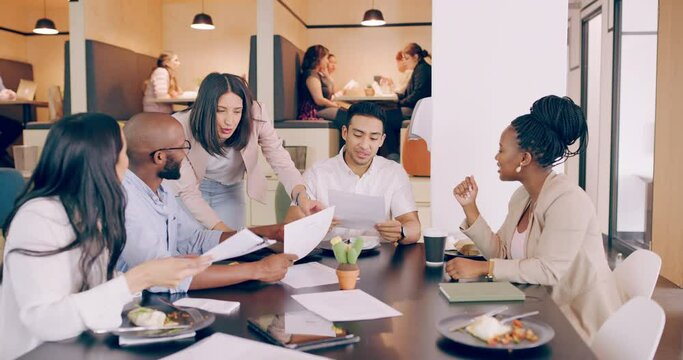 Its amazing what you can achieve if you do not care who gets the credit. 4k video footage of a group of young coworkers brainstorming over a lunch meeting in a restaurant.