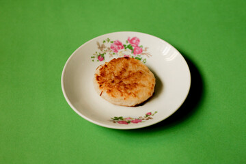 Traditional indonesian snack called wingko on plate. made from glutinous rice flour, sugar, and grated young coconut.
