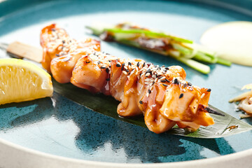 Japanese bbq - skewer yakitori with squid and teriyaki sauce. Grilled calamari on bamboo stick in...