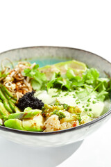 Vegan food - poke bowl with vegetables, edamame beans, soybean sprouts. Poke bowl with avocado and vegetables isolated on white background. Eat less meat. Plant - based eating.