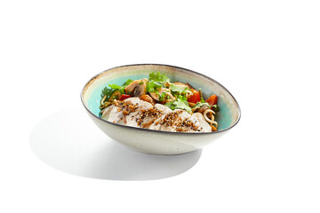 Healthy food in asian restaurant. Chicken breast grilled with roasted vegetables and coriander. Sliced Chicken fillet steak with teriyaki vegetables. Asian vegetables on wok with backed chicken.