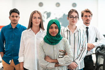 Portrait of young excited multiethnics business team of software developers standing and looking at...