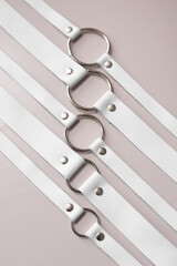 White leather fetish collars in different sizes. Fetish stuff for bdsm role playing games....