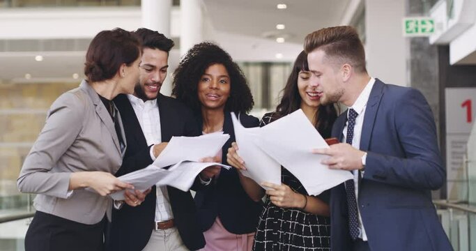 We prepared, we worked hard, now to celebrate. 4k video footage of a group of businesspeople celebrating by throwing paperwork in the air in an office.