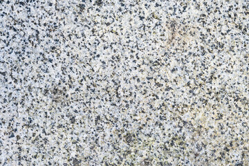 Textured granite rock, white with black speckles, as a natural  background
