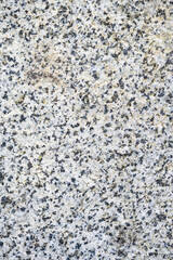 Textured granite rock, white with black speckles, as a natural  background
