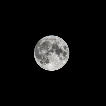 Detailed image of the full moon isolated on black.