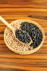 Brazilian beans. Spoon of black beans on brazilian grains in a wicker basket