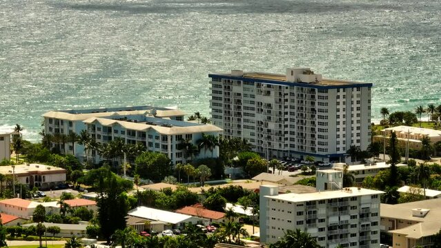 Aerial 7x zoom parallax video beachfront condos Deerfield FL USA