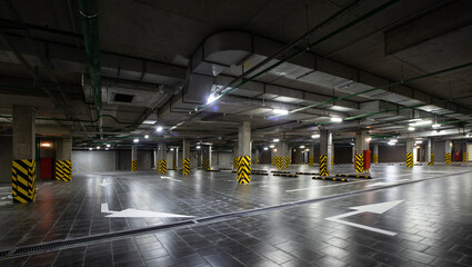 View of the underground parking, a lot of free places, in a shopping complex