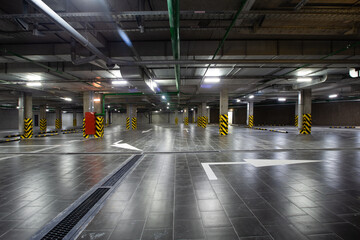 View of the underground parking, a lot of free places, in a shopping complex