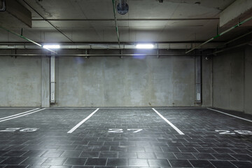 View of the underground parking, a lot of free places, in a shopping complex