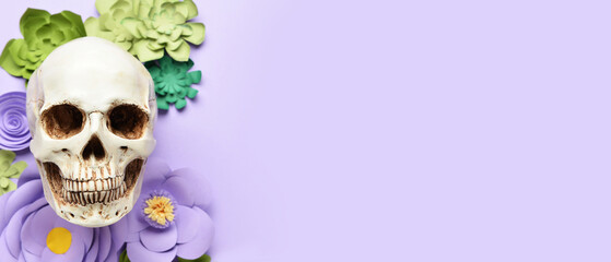 Human skull with handmade paper flowers on lilac background with space for text