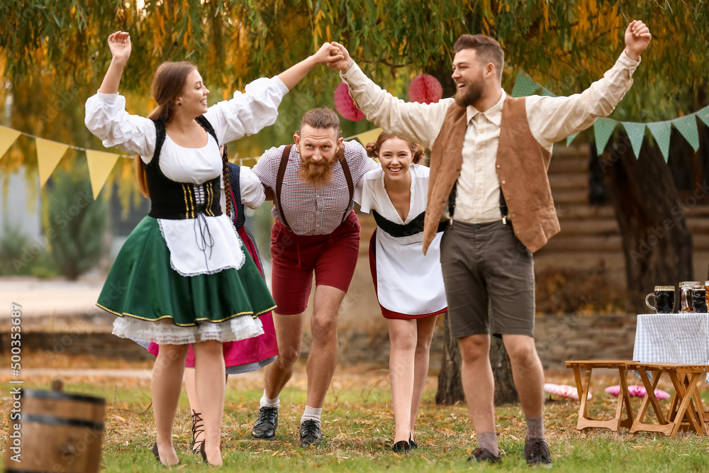 Poster Drunk people dancing and celebrating Octoberfest outdoors