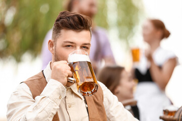 Man with beer celebrating Octoberfest outdoors