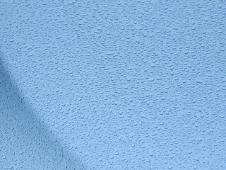 drops of water on the blue car after rain