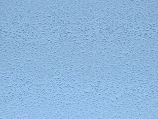 drops of water on the blue car after rain