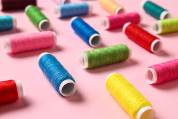 Thread spools on pink background