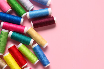 Thread spools on pink background