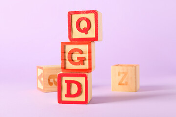 Cubes with letters on lilac background
