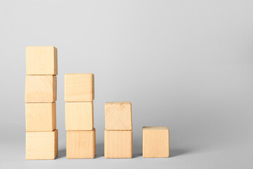 Wooden cubes on light background