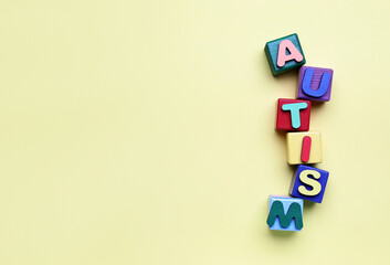 Cubes with word AUTISM on beige background