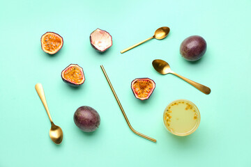 Fototapeta na wymiar Glass of juice, spoons, straw and delicious passion fruits on green background