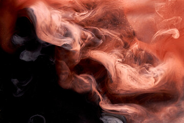 Orange smoke on black ink background, colorful fog, abstract swirling touch ocean sea, acrylic paint pigment underwater © amixstudio