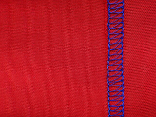 Blue thread of red fabric stitch, material texture