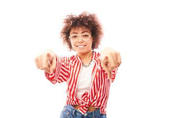 Portrait of friendly positive curly girl chooses you, points finger at the camera isolated on white background